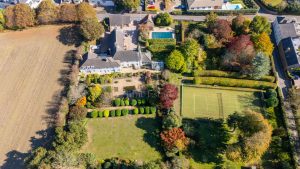 AN IMPRESSIVE FAMILY HOME WITH EXTENSIVE GROUNDS, POOL, AND TENNIS COURT