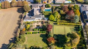 AN IMPRESSIVE FAMILY HOME WITH EXTENSIVE GROUNDS, POOL, AND TENNIS COURT
