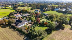 AN IMPRESSIVE FAMILY HOME WITH EXTENSIVE GROUNDS, POOL, AND TENNIS COURT