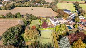 AN IMPRESSIVE FAMILY HOME WITH EXTENSIVE GROUNDS, POOL, AND TENNIS COURT