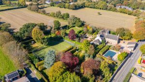 AN IMPRESSIVE FAMILY HOME WITH EXTENSIVE GROUNDS, POOL, AND TENNIS COURT