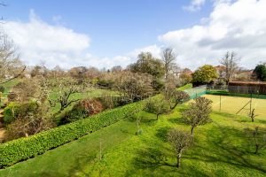 AN IMPRESSIVE FAMILY HOME WITH EXTENSIVE GROUNDS, POOL, AND TENNIS COURT