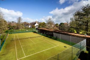 AN IMPRESSIVE FAMILY HOME WITH EXTENSIVE GROUNDS, POOL, AND TENNIS COURT