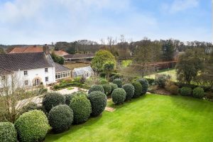 AN IMPRESSIVE FAMILY HOME WITH EXTENSIVE GROUNDS, POOL, AND TENNIS COURT