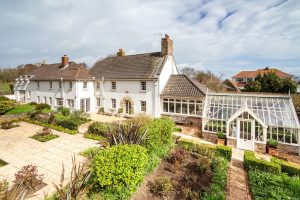 AN IMPRESSIVE FAMILY HOME WITH EXTENSIVE GROUNDS, POOL, AND TENNIS COURT
