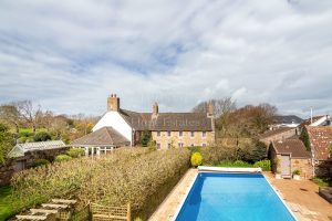 AN IMPRESSIVE FAMILY HOME WITH EXTENSIVE GROUNDS, POOL, AND TENNIS COURT