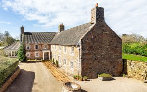 AN IMPRESSIVE FAMILY HOME WITH EXTENSIVE GROUNDS, POOL, AND TENNIS COURT